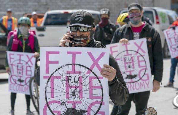 Gig economy protesters block a downtown street in Toronto, Ont. on May 1, 2020.