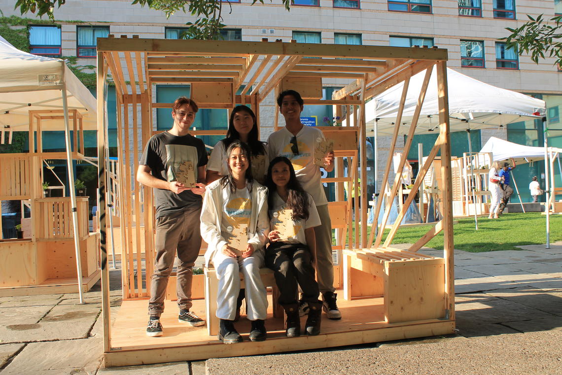 Reyvileen Soriano, front row, right, poses for a photo with team members inside their Ascend Garden Pavilion.