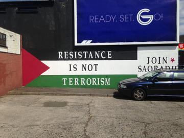 A mural along the Fall’s Road in Belfast that states “Resistance is Not Terrorism,” written on the Palestinian flag in solidarity with Palestine.