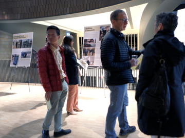 Individuals looking at images on easels