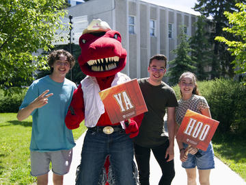 Rex poses with UCalgary Rex community members during the President's Stampede BBQ on July 12. 