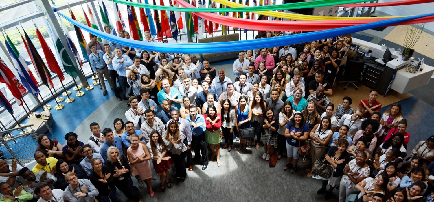 A group of X-Culture participants gets together for a group photo at a recent Global Symposium. Photo courtesy X-Culture