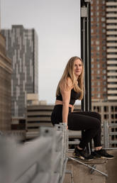 Jenn Varzari sits on a rooftop in downtown Calgary