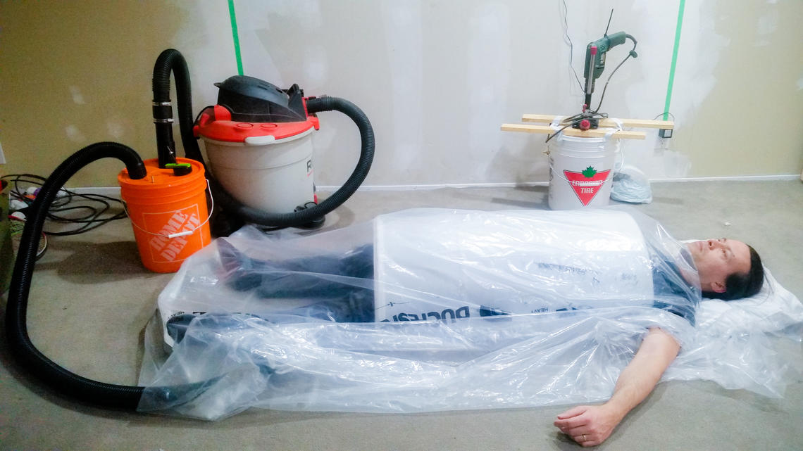 Then with the "poncho" over the top. In use you would duct tape the edges (or roll and clip like the old Emerson system did), pad the arm/collar and tape around them too. I am not doing that now because the pressure-relief valves aren't tuned yet. At some point I will upload a video crushing something with the vacuum cleaner, poly and duct tape to show how good the seal is, but we won't start with me