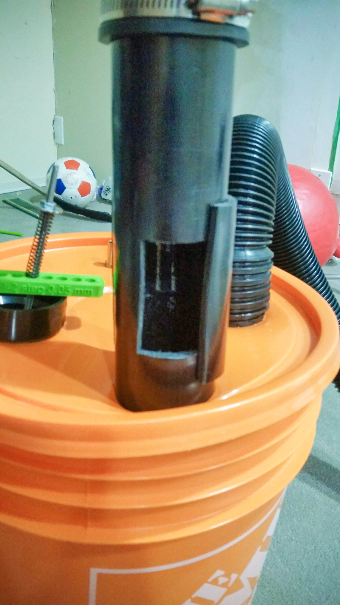 Another option, not self-actuating but could provide coarser pre-adjustment before fine tuning with the sprung valve above. A section of PVC pipe with a hole cut out, and a second section of the same pipe with 1/3 of the circumference removed stretched over the top as a manually adjustable cover.