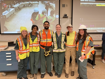 CPR Competition participant group wearing fluorescent construction attire.