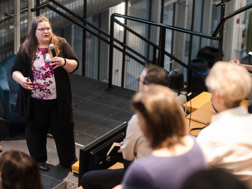 A woman presenting to an audience