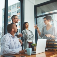 Four people discussing in an office